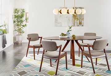 Modern living room with a round table, upholstered chairs and geometric accents